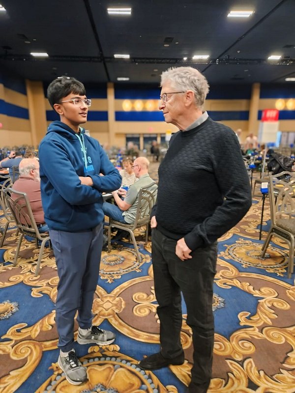 Anshul Bhatt in conversation with Bill Gates in a bridge tournament hall