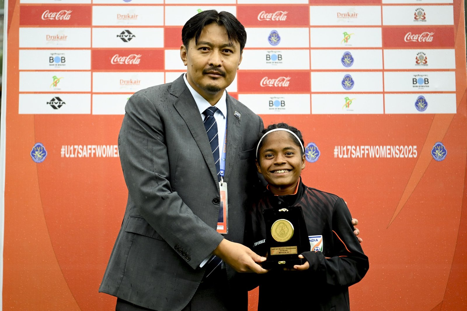 Anushka Kumari holding her SAFF U-17 award plaque