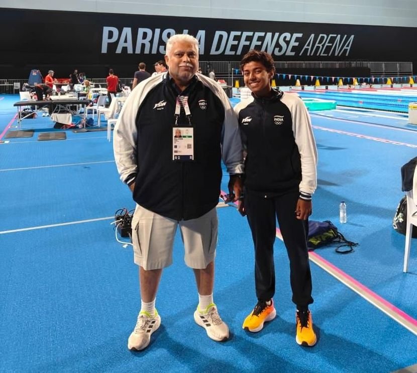 Dhinidhi Desinghu with a coach, in the World Aquatics feature