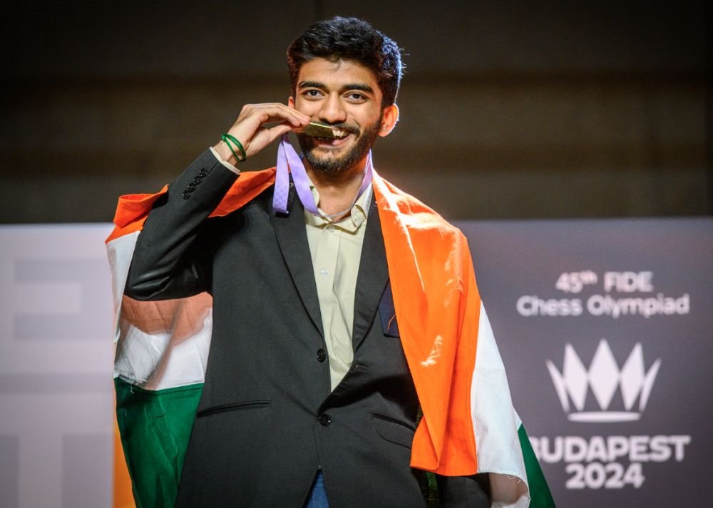 Gukesh Dommaraju draped in the Indian flag, holding up his gold medal at the 45th FIDE Chess Olympiad, Budapest 2024