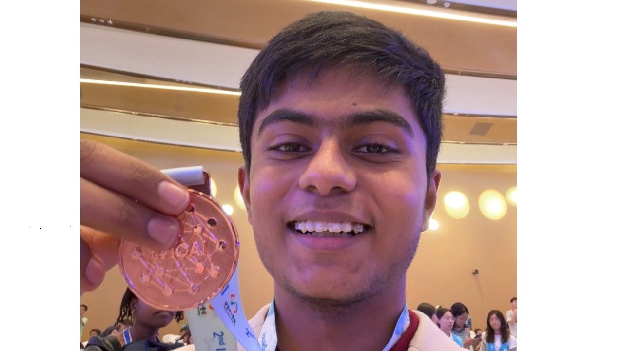 Himaneesh Sompalle holding his IOAI bronze medal, in the named source report