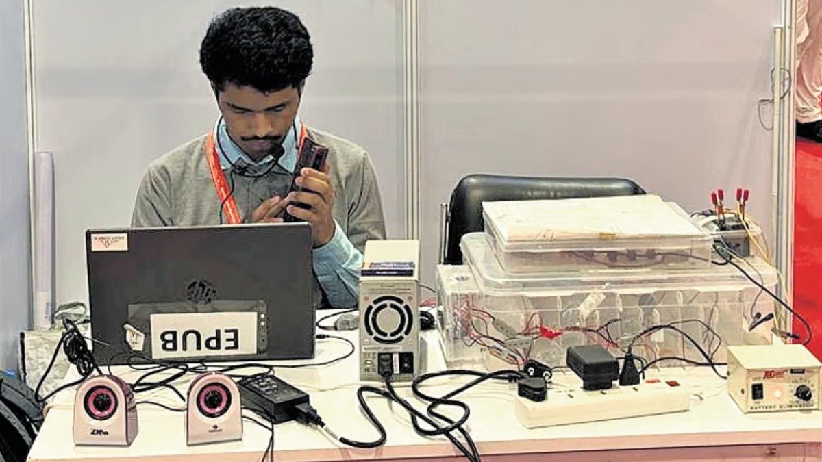 Rehan Raza demonstrating his talking medicine box at his exhibition stall