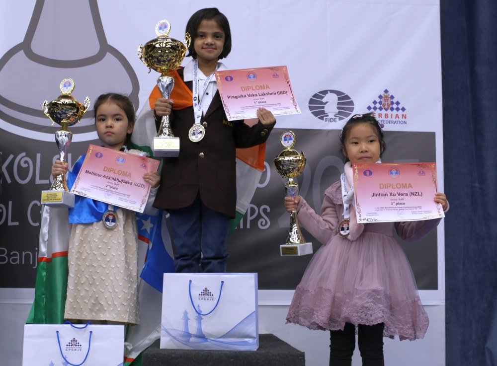 Girls Under-7 podium; the centre certificate names Pragnika Vaka Lakshmi in first place